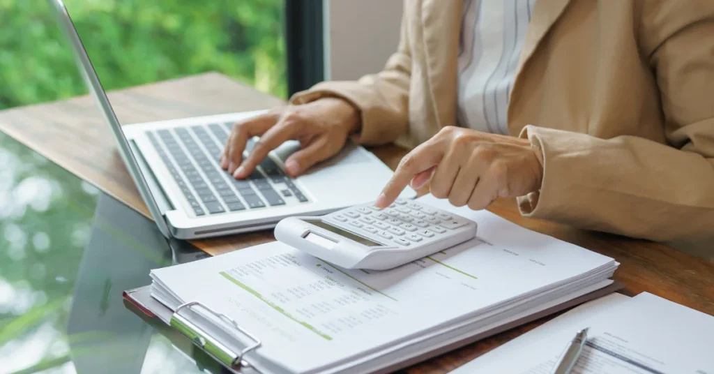 Empresaria revisando estados financieros e indicadores de crecimiento para asegurar la autonomía económica de su empresa.